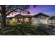 Charming single-story home with a well-manicured lawn, mature trees, and a two-car garage at 8158 Woodvine Cir, Lakeland, FL 33810