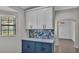 Kitchen features blue base cabinets with white countertops and upper cabinets at 8158 Woodvine Cir, Lakeland, FL 33810