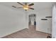 Bright living room featuring wood floors, a ceiling fan, and arched doorway leading to the kitchen at 8158 Woodvine Cir, Lakeland, FL 33810