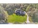 Expansive property with an aerial view of a well-maintained home, lush greenery, and a winding driveway at 9216 Tom Moore Rd, Lakeland, FL 33810
