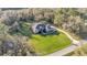 Overhead view of a property, highlighting its large lot, screened-in pool, and long private driveway at 9216 Tom Moore Rd, Lakeland, FL 33810