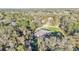 High-angle aerial perspective showcasing a home nestled in a wooded area, offering privacy and tranquility at 9216 Tom Moore Rd, Lakeland, FL 33810