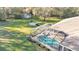 An aerial shot of the screened-in pool area with lush landscaping at 9216 Tom Moore Rd, Lakeland, FL 33810