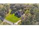 Bird's-eye view of a property featuring a lush lawn and a sprawling, wooded landscape at 9216 Tom Moore Rd, Lakeland, FL 33810