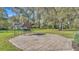 Paver patio in a large backyard features a swing and a shed at 9216 Tom Moore Rd, Lakeland, FL 33810