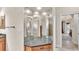 Bathroom vanity featuring a granite countertop, custom mirrors and vanity lighting at 9216 Tom Moore Rd, Lakeland, FL 33810