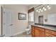 Well-lit bathroom with a wood vanity, granite countertop, and a framed mirror at 9216 Tom Moore Rd, Lakeland, FL 33810