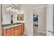 Bathroom featuring a wood vanity, granite countertop, and a view of a closet space at 9216 Tom Moore Rd, Lakeland, FL 33810