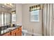 Bathroom features a granite countertop, wood cabinetry and a shower/tub combo at 9216 Tom Moore Rd, Lakeland, FL 33810