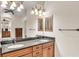 Bathroom featuring granite countertop, dual sinks, and ample lighting fixtures at 9216 Tom Moore Rd, Lakeland, FL 33810