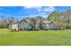 Charming single-story home with a lush green lawn, stone accents, and beautiful landscaping at 9216 Tom Moore Rd, Lakeland, FL 33810