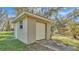 Detached garage features a white garage door, a side door, and a window at 9216 Tom Moore Rd, Lakeland, FL 33810