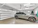 Spacious three-car garage with ample storage space and a clean, epoxy-coated floor, fits two cars at 9216 Tom Moore Rd, Lakeland, FL 33810