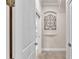 Hallway with neutral paint and tile floor that leads to multiple rooms at 9216 Tom Moore Rd, Lakeland, FL 33810