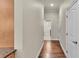 Hallway with hardwood floors and neutral walls, leading to other rooms in the home at 9216 Tom Moore Rd, Lakeland, FL 33810