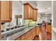 Kitchen with stainless appliances, granite countertops and wood cabinets opens up to the living room at 9216 Tom Moore Rd, Lakeland, FL 33810