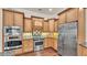 Kitchen with stainless appliances, granite countertops and wood cabinets, including a built-in microwave and oven at 9216 Tom Moore Rd, Lakeland, FL 33810