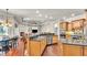 Gourmet kitchen with granite countertops, custom cabinetry, and stainless steel appliances, seamlessly flowing into the living area at 9216 Tom Moore Rd, Lakeland, FL 33810