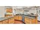 Kitchen with stainless appliances, granite countertops and wood cabinets opens up into the living room at 9216 Tom Moore Rd, Lakeland, FL 33810