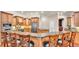 Spacious kitchen features granite countertops, stainless steel appliances, wood cabinets and breakfast bar with seating at 9216 Tom Moore Rd, Lakeland, FL 33810