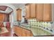 Kitchen with stainless appliances, granite countertops and wood cabinets opens up to archway at 9216 Tom Moore Rd, Lakeland, FL 33810