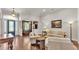 Bright living room with hardwood floors, neutral furniture, and a view into the office at 9216 Tom Moore Rd, Lakeland, FL 33810