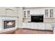 Living room features a fireplace with white mantle and built in cabinets with glass shelving at 9216 Tom Moore Rd, Lakeland, FL 33810