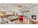 Spacious living room featuring an open floor plan, hardwood floors, a cozy fireplace, and access to the backyard at 9216 Tom Moore Rd, Lakeland, FL 33810