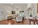 Inviting living room showcasing hardwood floors, comfortable seating, and natural light streaming through the windows at 9216 Tom Moore Rd, Lakeland, FL 33810