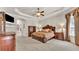 Spacious bedroom features tray ceilings, a large window, and a full ensuite bathroom at 9216 Tom Moore Rd, Lakeland, FL 33810
