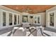 Covered patio features ample seating and ceiling fan for relaxing and entertaining outdoors at 9216 Tom Moore Rd, Lakeland, FL 33810