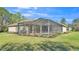 Enclosed pool area featuring a screened-in enclosure and beautiful backyard at 9216 Tom Moore Rd, Lakeland, FL 33810