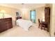 Cozy bedroom features a bed, dresser, and desk with natural light from the window at 1007 Elizabeth Ln, Lakeland, FL 33809