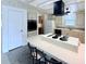 Kitchen island with stovetop and breakfast bar seating in neutral color palette at 1007 Elizabeth Ln, Lakeland, FL 33809