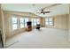 Bright and airy living room with plenty of windows, neutral carpet, and ceiling fan at 1007 Elizabeth Ln, Lakeland, FL 33809