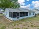 Back of home showing the lanai, backyard and mature landscaping at 1064 Penguin Pl, Lakeland, FL 33809