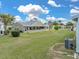 Well-kept backyard featuring green lawn, a screened-in porch, and a comfortable outdoor area at 1064 Penguin Pl, Lakeland, FL 33809