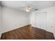 Bedroom features wood flooring, a ceiling fan, and a closet at 1064 Penguin Pl, Lakeland, FL 33809