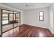 Bedroom with hardwood floors, ceiling fan, and sliding glass doors to the porch at 1064 Penguin Pl, Lakeland, FL 33809