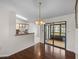 Dining area featuring hardwood floors adjacent to a counter bar with sliding glass doors at 1064 Penguin Pl, Lakeland, FL 33809