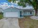 Delightful one-story home with attached garage, a well-kept lawn and inviting curb appeal at 1064 Penguin Pl, Lakeland, FL 33809