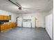 Spacious garage with laundry hookups, cabinets, and an electric door at 1064 Penguin Pl, Lakeland, FL 33809