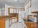 Spacious kitchen featuring white cabinets, stainless appliances, and granite countertops at 1064 Penguin Pl, Lakeland, FL 33809