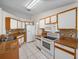 Well-lit kitchen featuring white cabinets, granite countertops, and tile flooring at 1064 Penguin Pl, Lakeland, FL 33809