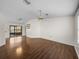 Open living room featuring hardwood floors with chandelier and sliding glass doors to enclosed porch at 1064 Penguin Pl, Lakeland, FL 33809