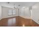 Open living room featuring hardwood floors, a ceiling fan, and a bright front door at 1064 Penguin Pl, Lakeland, FL 33809