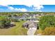 An aerial shot shows this residential home nestled among the surrounding neighborhood at 107 Amber Blvd, Auburndale, FL 33823