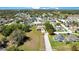 Overhead shot showing the home's placement within the neighborhood, surrounded by mature trees and lawns at 107 Amber Blvd, Auburndale, FL 33823