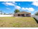 An open backyard features a covered patio, enhancing the outdoor living space at 107 Amber Blvd, Auburndale, FL 33823