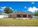 A fully fenced backyard with a covered patio, perfect for outdoor entertaining and privacy at 107 Amber Blvd, Auburndale, FL 33823